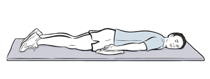 Man lying on stomach with arms at side.